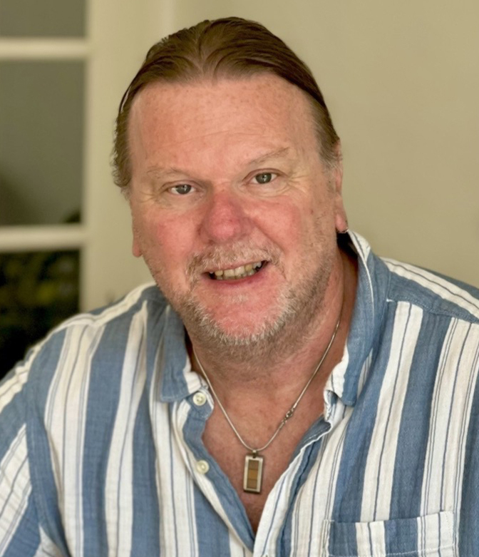 Portrait of Anthony Stock of Tiger Furniture, in a blue and white striped shirt.